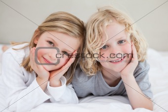 Brother and sister lying on the bed