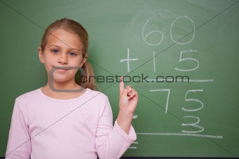Cute schoolgirl raising her hand