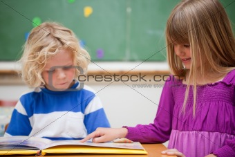 Pupils reading a book