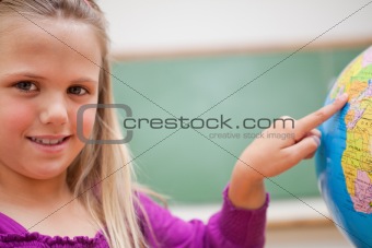 Close up of a schoolgirl pointing at a country