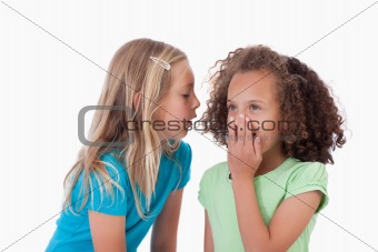 Girl whispering a secret to her friend