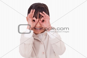 Girl putting her fingers around her eyes