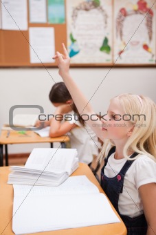 Portrait of a pupil raising her hand