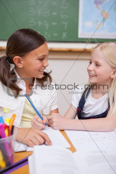 Portrait of happy pupils working together on an assignment