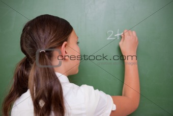 Schoolgirl writing an addition