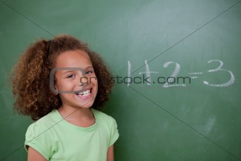 Schoolgirl posing in front of an addition