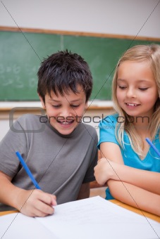 Portrait of happy pupils working together
