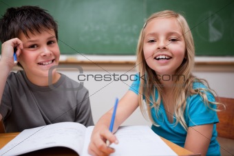 Two children writing