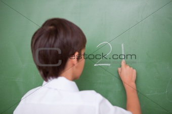 Schoolboy writing an addition