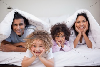 Family playing in the bedroom together