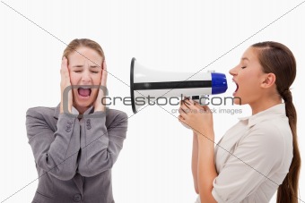 Young manager yelling at her employee through a megaphone