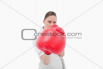 Serious businesswoman boxing