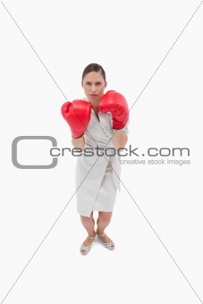 Portrait of a serious businesswoman with boxing gloves