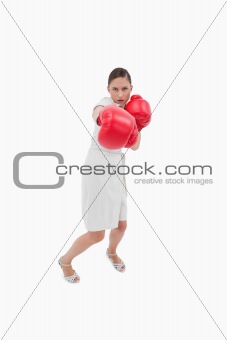 Portrait of a businesswoman punching someone