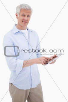 Portrait of a smiling mature man using a tablet computer
