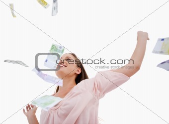 Woman under bank notes falling