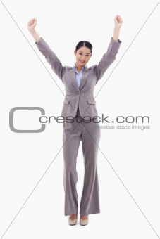 Portrait of a happy businesswoman posing with the arms up