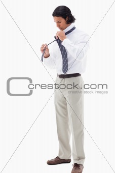 Portrait of an office worker putting his tie
