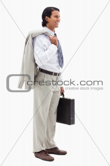 Portrait of a smiling office worker holding his jacket over his shoulder and a briefcase