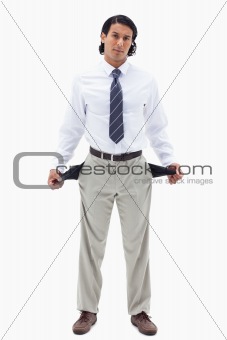 Portrait of a broke businessman showing his empty pockets