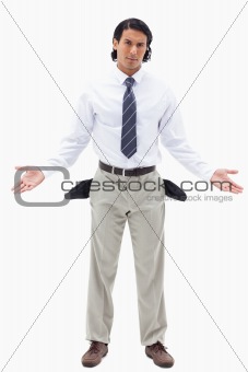 Portrait of an innocent businessman showing his empty pockets
