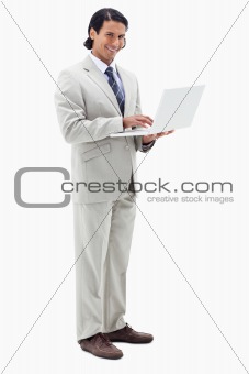 Portrait of a smiling businessman using a notebook