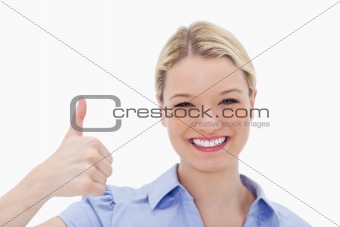 Smiling woman giving thumb up