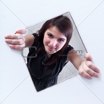 Teenager crawling and peeking out of a hole