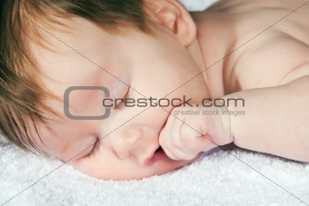 infant about two month on white towel