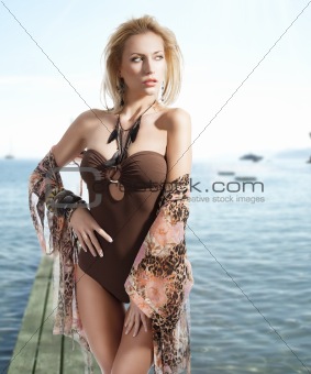 summer portrait of blond young girl, she looks at left with sexy