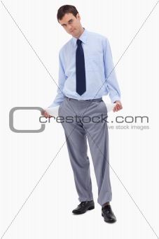 Businessman showing his empty pockets