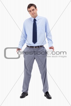 Broke businessman showing his empty pockets