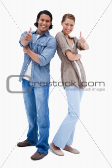 Smiling couple giving thumbs up