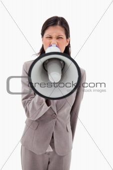 Angry businesswoman yelling through megaphone