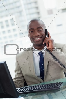 Portrait of a smiling office worker making a phone call
