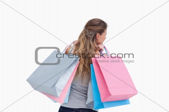 Back view of a woman holding shopping bags