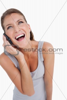 Portrait of a laughing woman making a phone call