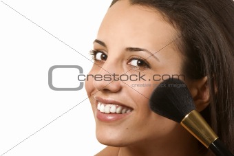 young woman applying blusher