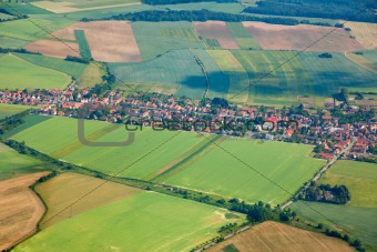 Aerial view of countryside with village and farmland
