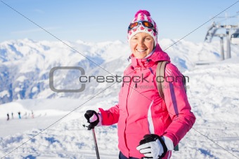 Young woman with skis and a ski wear