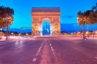 Evening traffic on Champs-Elysees in front of Arc de Triomphe (P