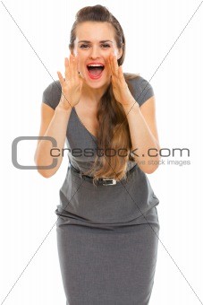 Business woman shouting through megaphone shaped hands