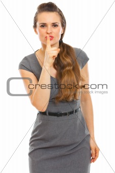 Business woman showing shhh... gesture