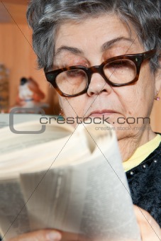portrait of senior woman reading book