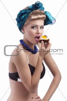 blond young girl eating sweet 