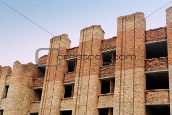 Collapsing unfinished brick building