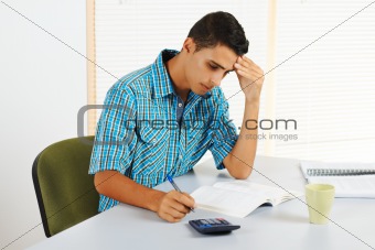 Young man trying to study