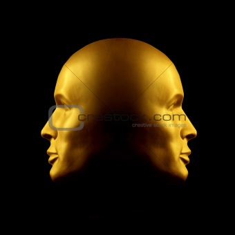 Two-faced gold head statue