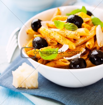 Penne pasta with pesto and olives