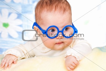 portrait of funny baby with glasses